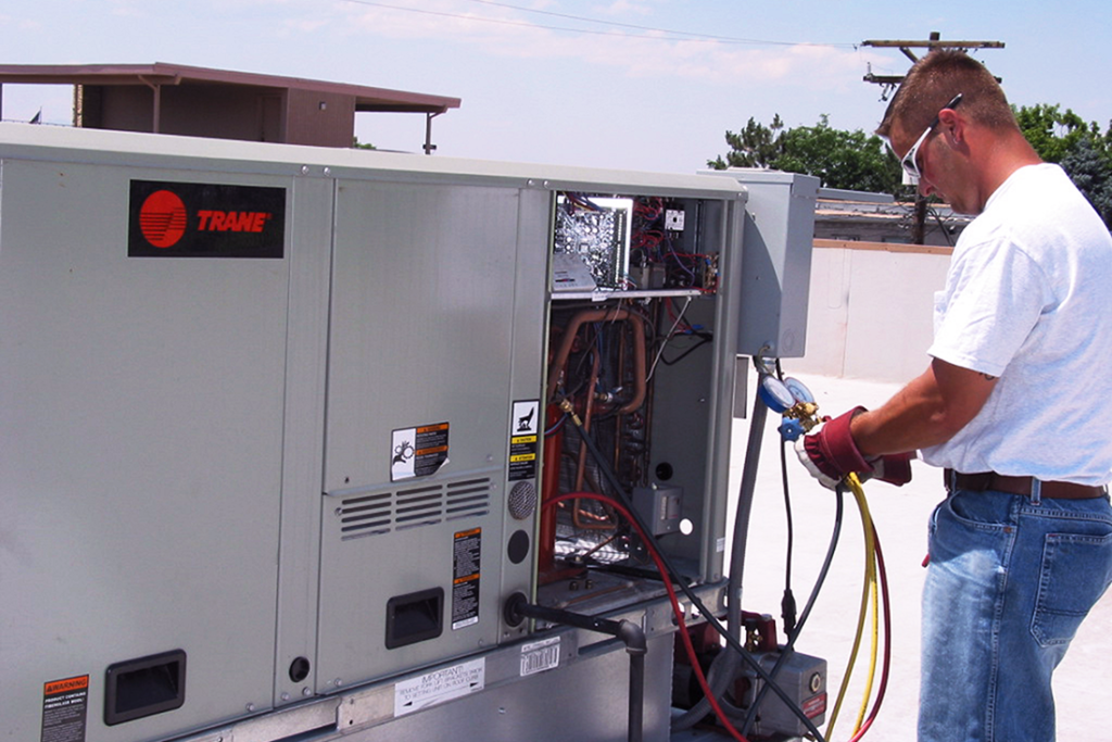 Scott of CMI checking levels on a rooftop air-conditioner